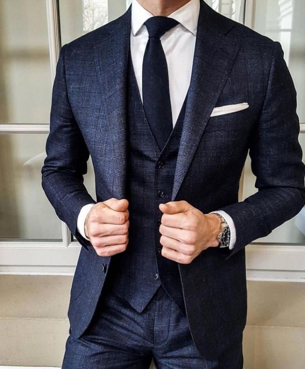 Navy three-piece suit with white pocket square